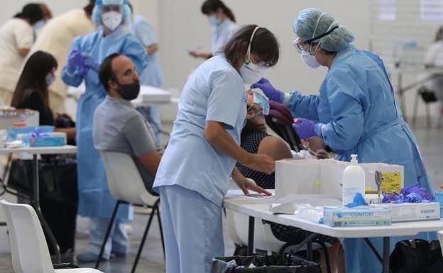 Stock image of health personnel performing covid tests. 