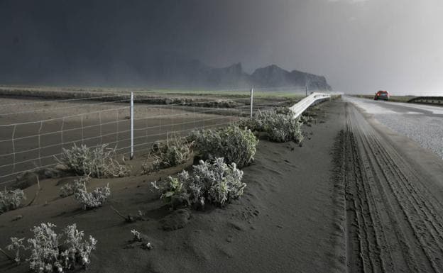 'A car drives down an Icelandic road covered in ash from the Eyjafjallajökull volcano in May 2010.