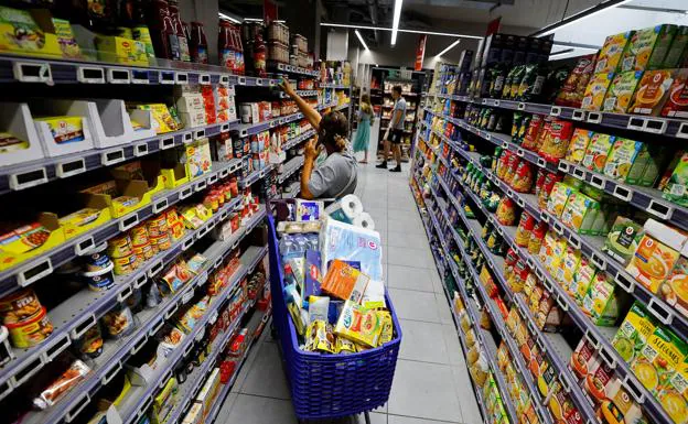 A woman shops in a supermarket in Italy.