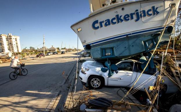 Un barco se asienta sobre un coche en Fort Myers, Florida. /efe